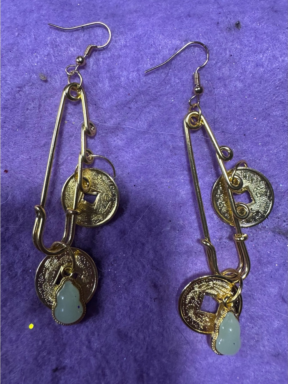 Gold Tone safety pin earrings with Lucky Coin and green pair charms.
